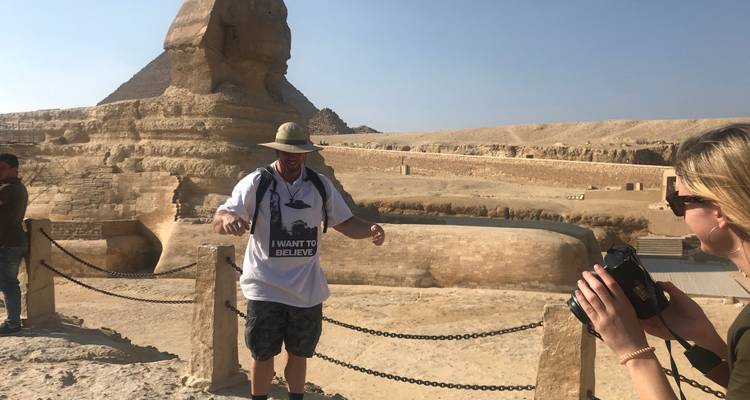 A person visiting the Sphinx with another person taking a photo.