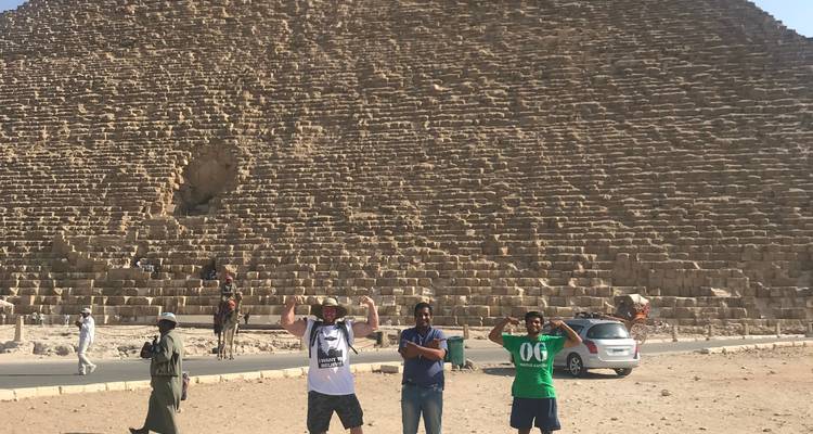 A group of people standing in front of the Great Pyramid.