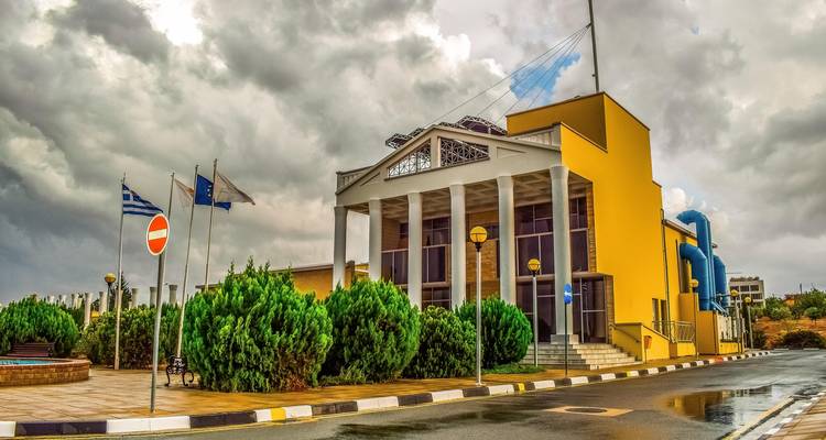 Institutional building with flags in front of it.