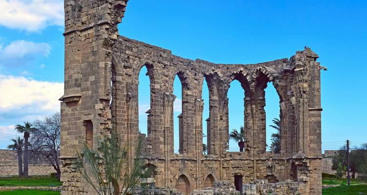 Ruined arches of a historical stone structure.