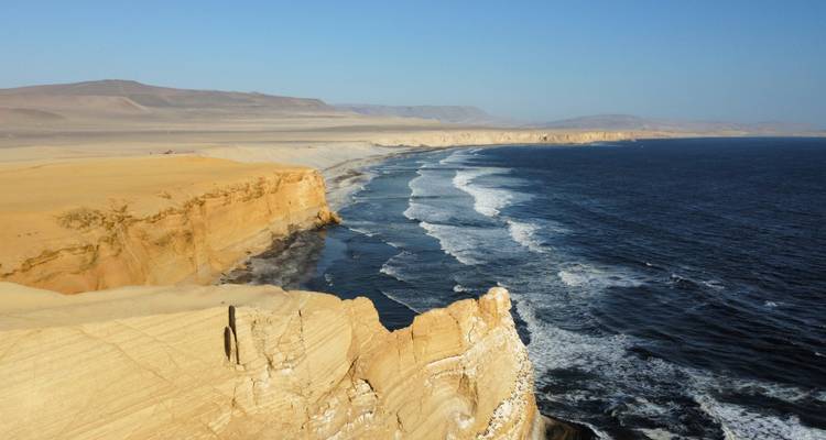 Dramatic coastline with cliffs and ocean waves.