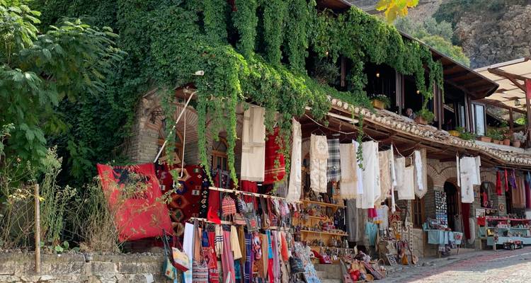 Craft market with woven textiles and souvenirs.