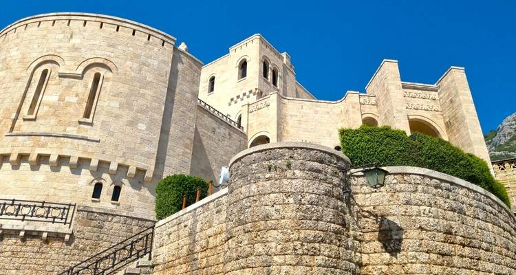 A historic stone fortress under a clear blue sky.