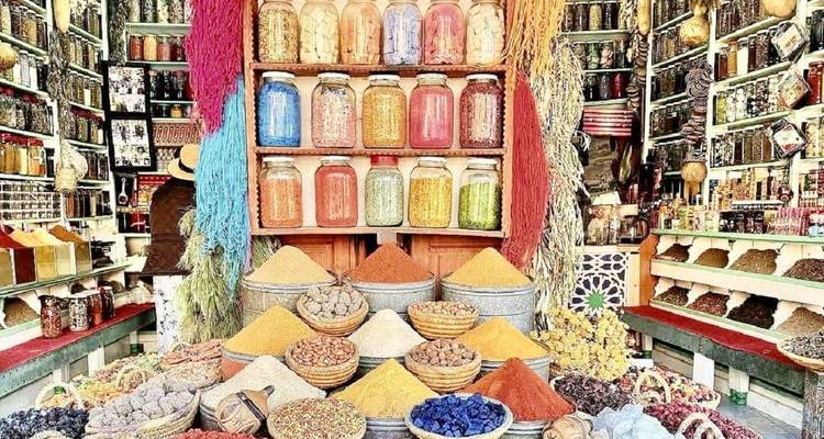 Shop displaying colorful spices in jars and baskets.