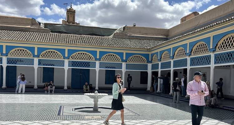 Tourists exploring a historical courtyard with intricate architecture.