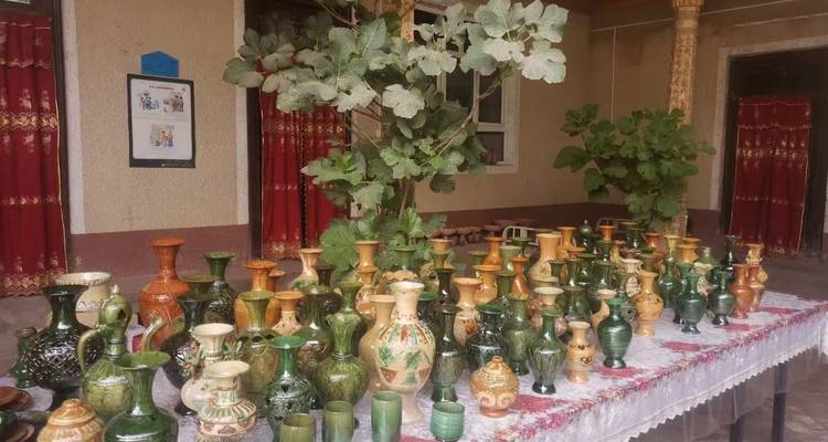 A variety of colorful pottery displayed on a table.