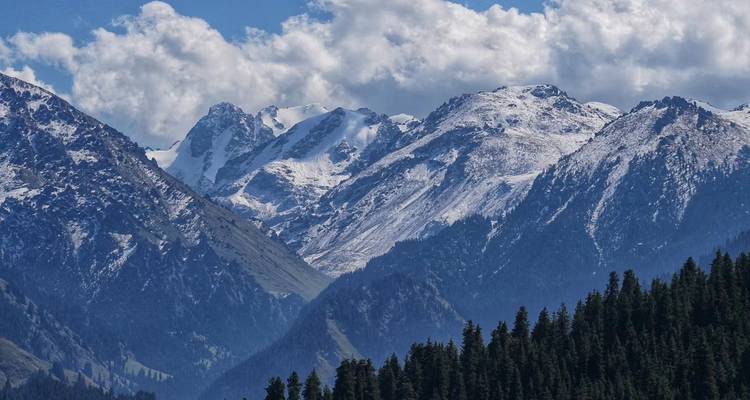 Snow-capped mountain peaks under a clear blue sky.