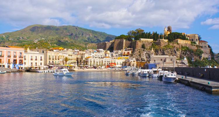 Vibrant coastal town view with boats and buildings.