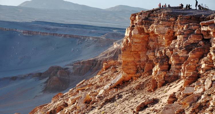 Rugged mountainous landscape with adventurers on the edge.