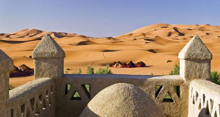 Desert palace overlooking sand dunes.
