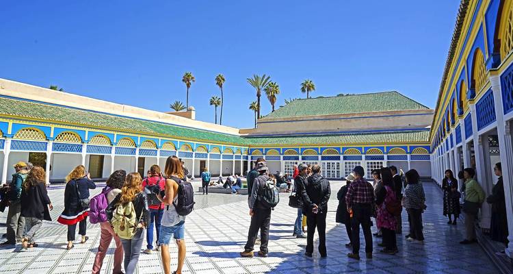 Group of tourists in a palace courtyard