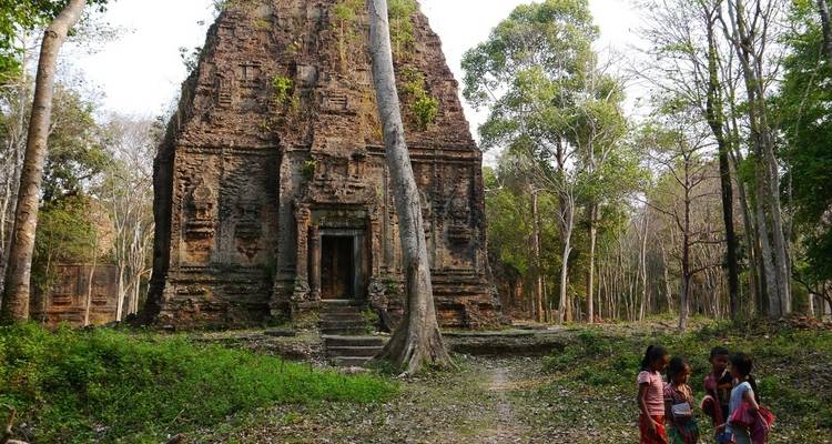 Group of children near an ancient temple in the forest.