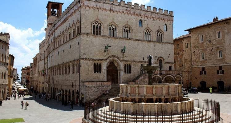 Fountain and historic building in Perugia city square.