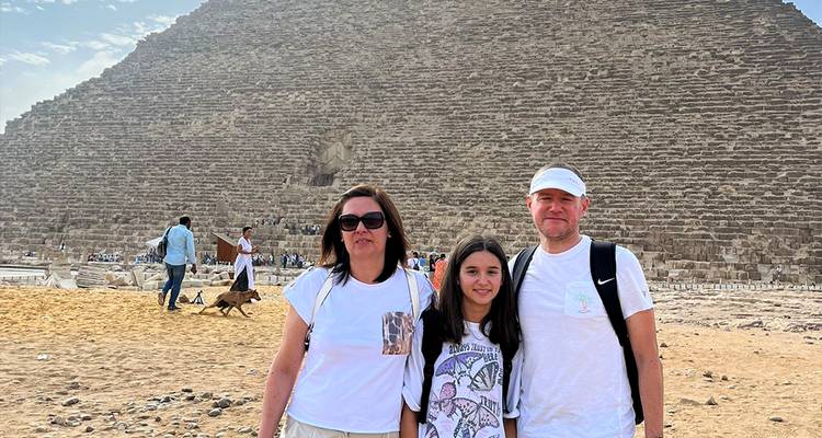 Family posing in front of the Great Pyramid of Giza.