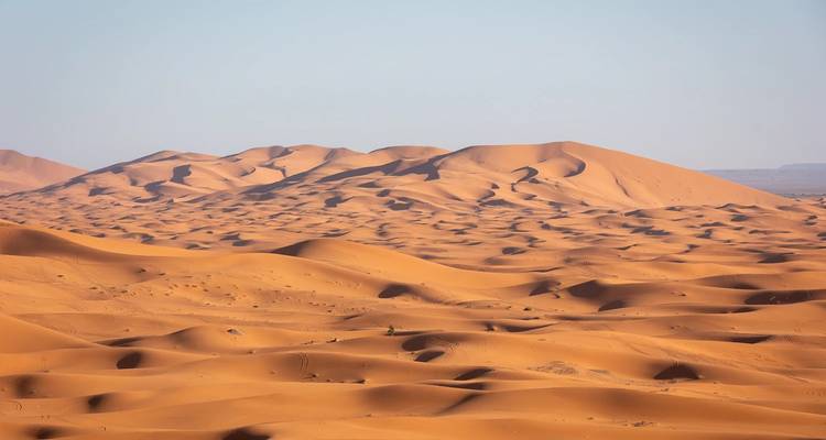 Vast desert landscape with sand dunes.