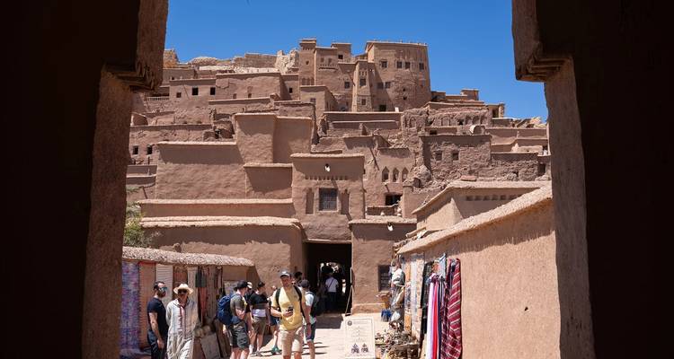 Historic Kasbah with people walking through.