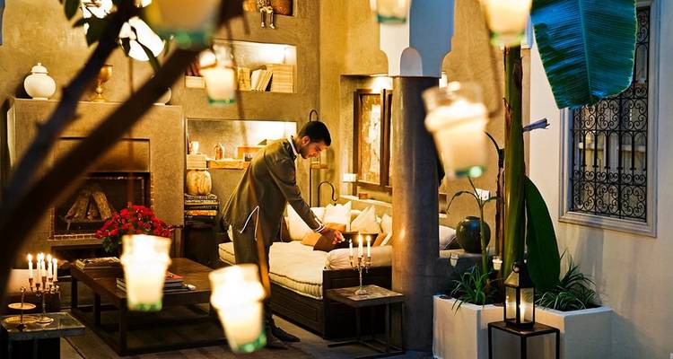 Cozy interior with a person arranging beddings.