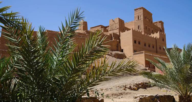 Traditional Moroccan fortress surrounded by greenery.