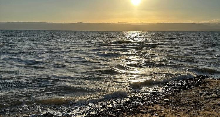 Sunset reflecting on a large body of water.