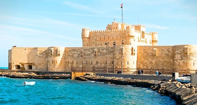 A fortress standing by the sea, facing the waves.