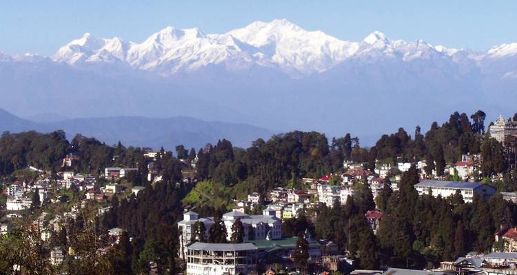 A town with a backdrop of majestic snow-covered mountains.