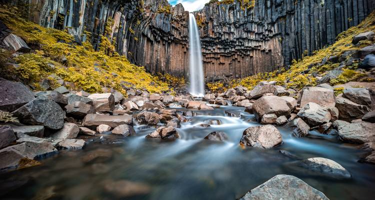 Beautiful waterfall cascading over basalt columns.