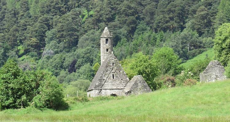 Historic church surrounded by lush greenery.