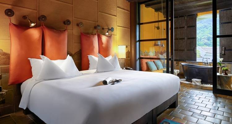 Elegant hotel room with large bed and outdoor view