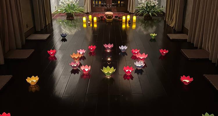 Lit candles and flower arrangements in a dim room