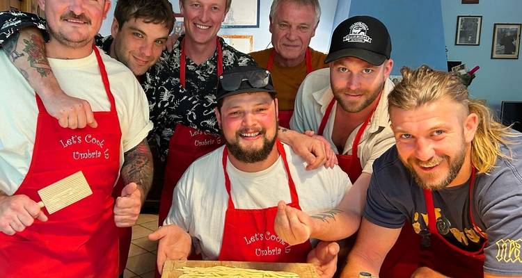Group of people posing with homemade pasta.