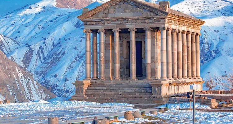 Ancient Greek-style temple with snowy mountains.