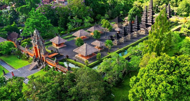 Traditional Balinese temple complex in greenery.