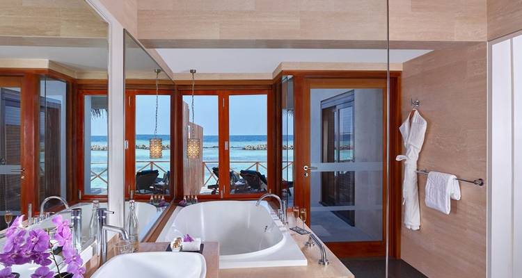 Bathroom view overlooking the ocean from a villa.