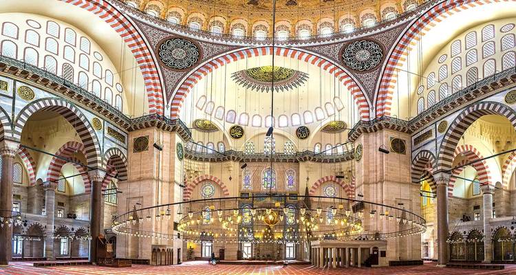Lavish interior of a mosque with ornate designs.