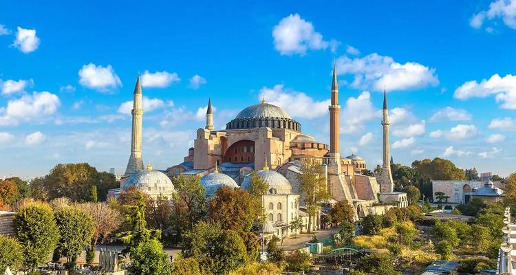 Iconic historic building with minarets under a blue sky.