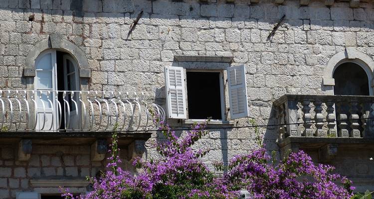 Historic stone building with flowers.