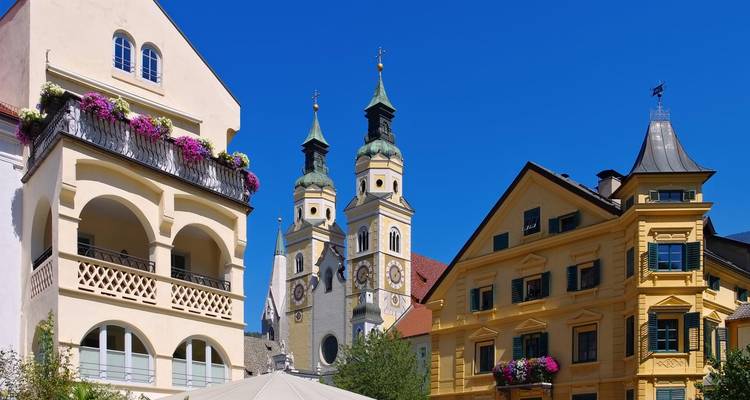 Encantador pueblo alpino con catedral de torres gemelas contra un cielo azul profundo