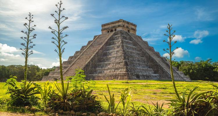 Chichen Itza pyramid with surrounding greenery.