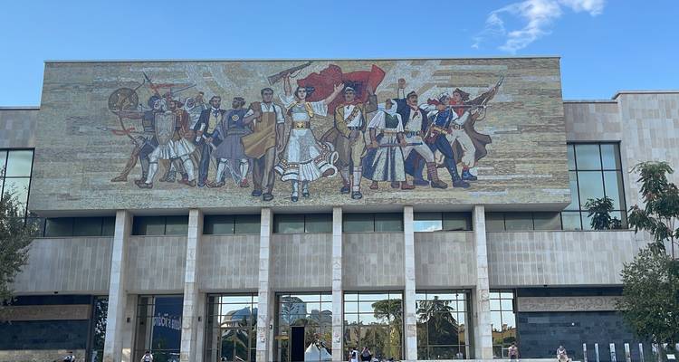 Building with a large mosaic mural on the facade.