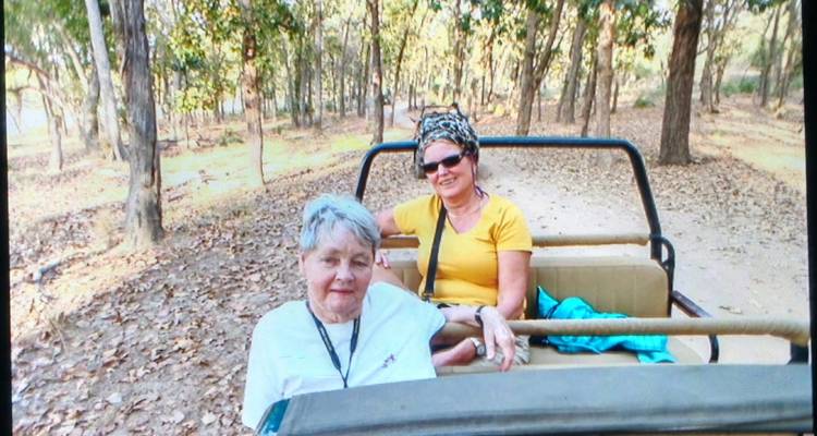 Zwei Frauen sitzen in einem Jeep auf einer Safari.