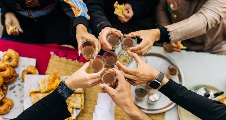 Group of friends toasting with beverages.