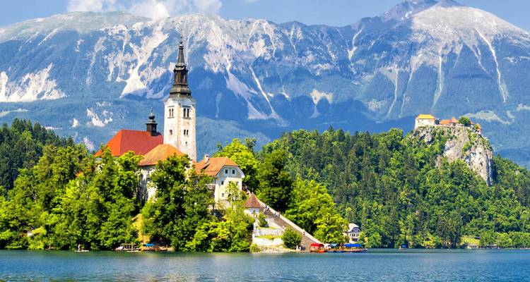Church on an island with mountains in the background.