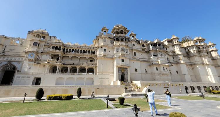 Magnificent palace with intricate details and people visiting.