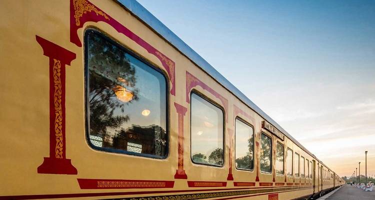 Luxurious train with ornate design against a clear sky.