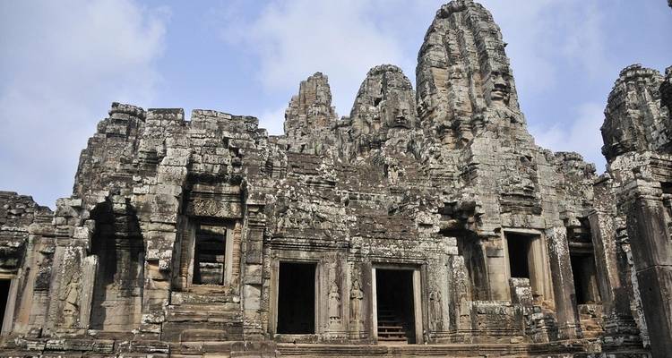 Angkor temple ruins with face towers.