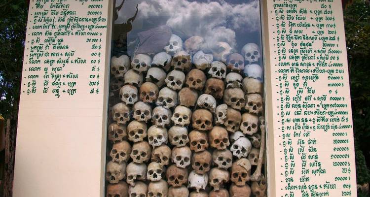 Glass case filled with historical skulls and inscriptions.