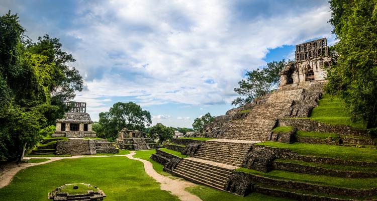 Mayan ruins with grassy surrounding.