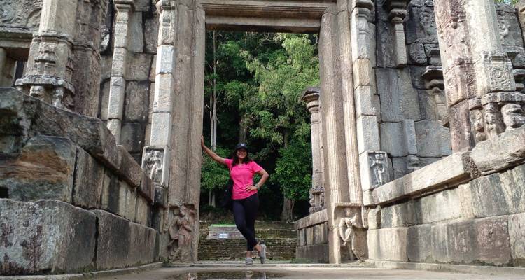 Person standing in an ancient stone doorway.
