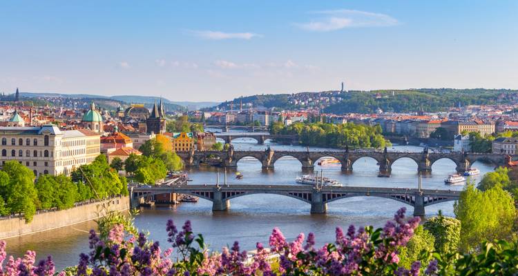 Vista primaveral de Praga con su río serpenteante y puentes.
