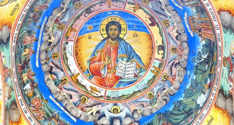 A richly decorated religious fresco showing Christian iconography inside a dome.